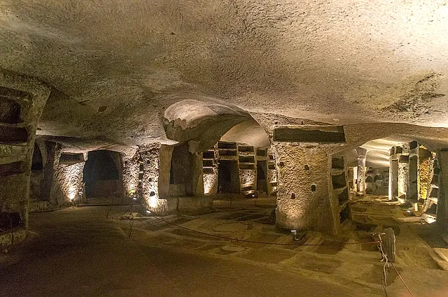 A lit gallery with burial niches in the Catacombs of San Gennaro, Naples