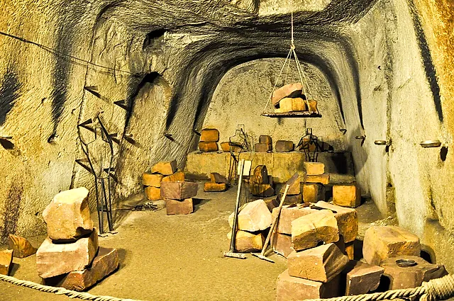 Reconstruction of a tuff quarry with cut blocks and tools in the Naples underground