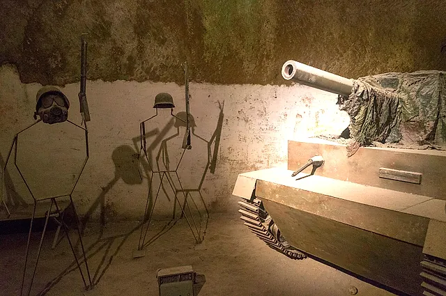 A wartime display with a tank and soldier silhouettes in a tuff cavern of the Naples underground