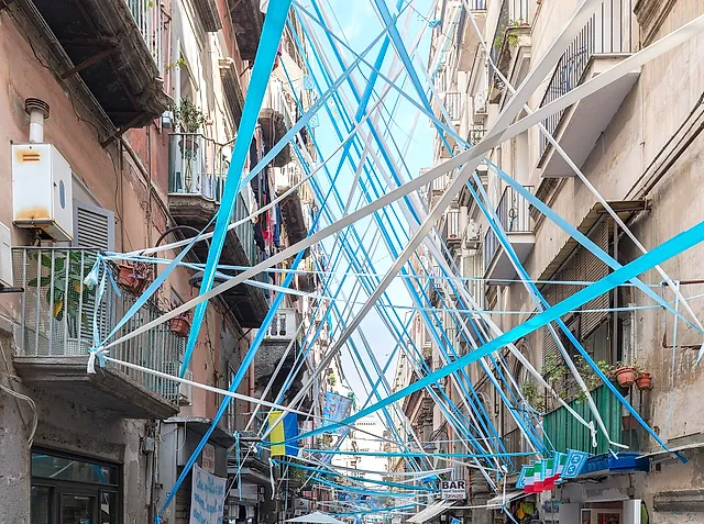 Via dei Tribunali in the historic centre of Naples, with festive ribbons hung between the buildings